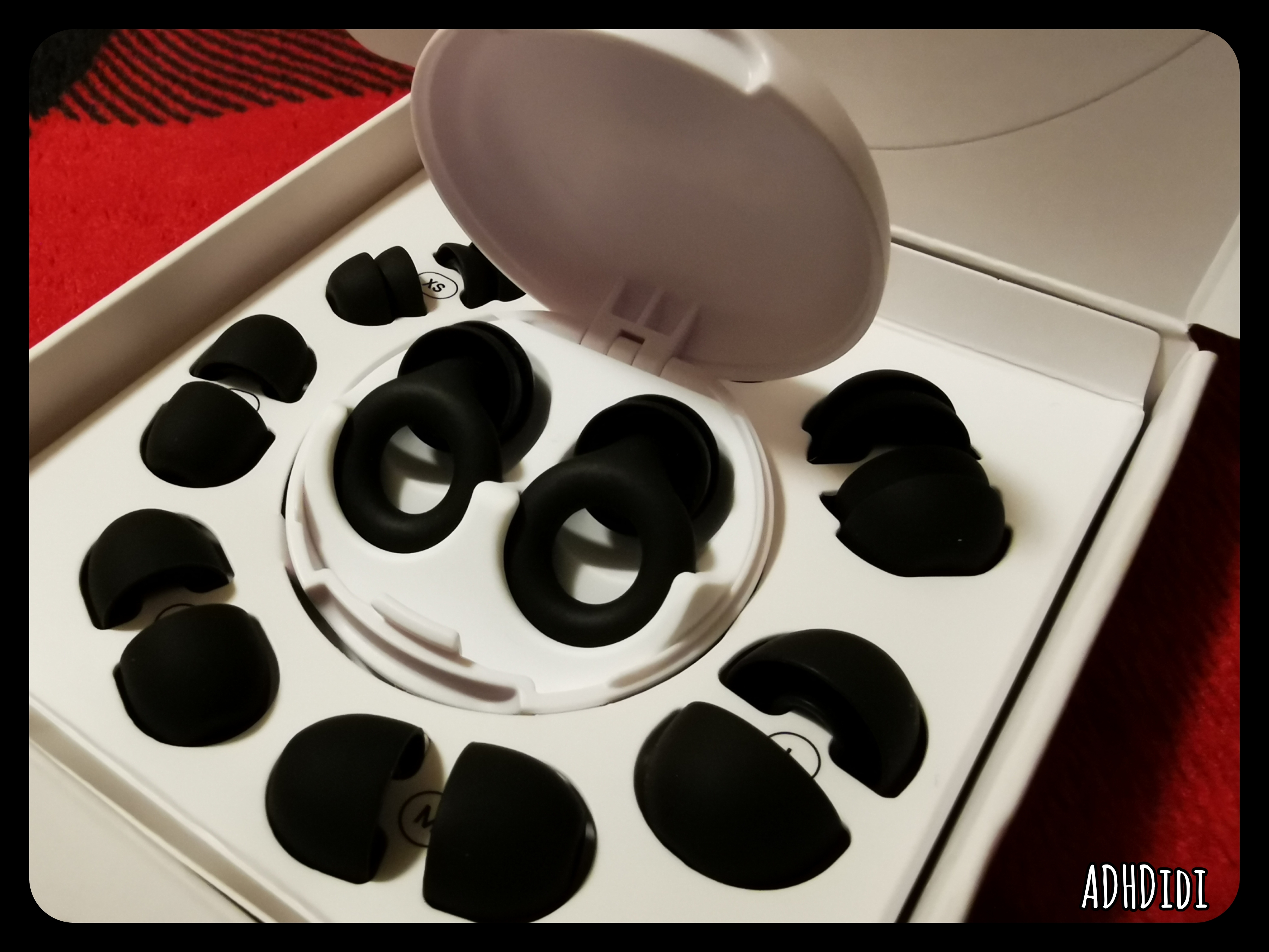 A picture of my black Loop Quiet 2 Plus earplugs, in their white box with all the different sizes in a circle.
