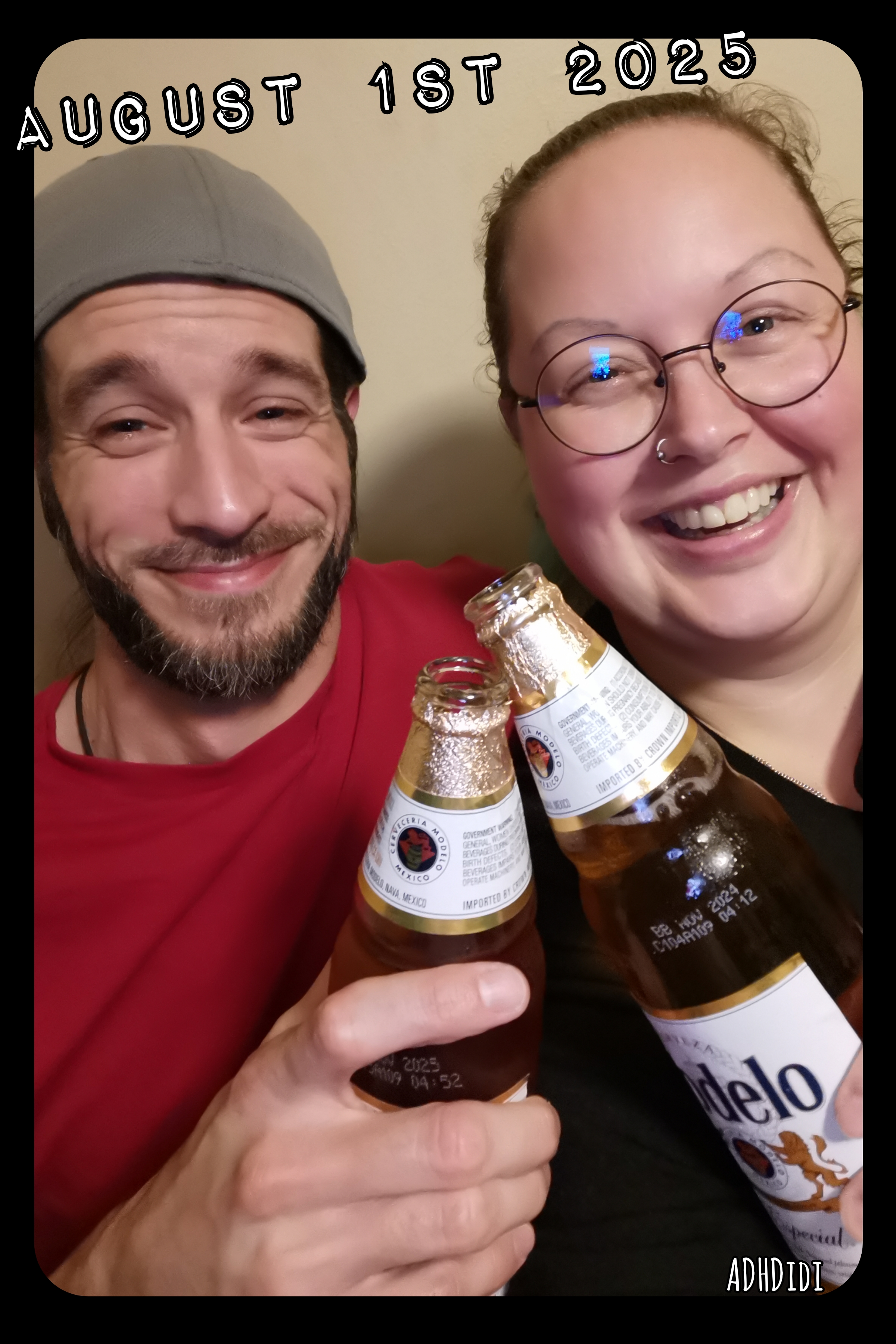 Picture of David and Didi. David is wearing a bright red shirt and grey backwards cap. Didi is wearing a black shirt and round glasses with a thin black frame. They are both looking into the camera while smiling widely and toasting with Modelo beer bottles. Text above them reads "August 1st 2025".